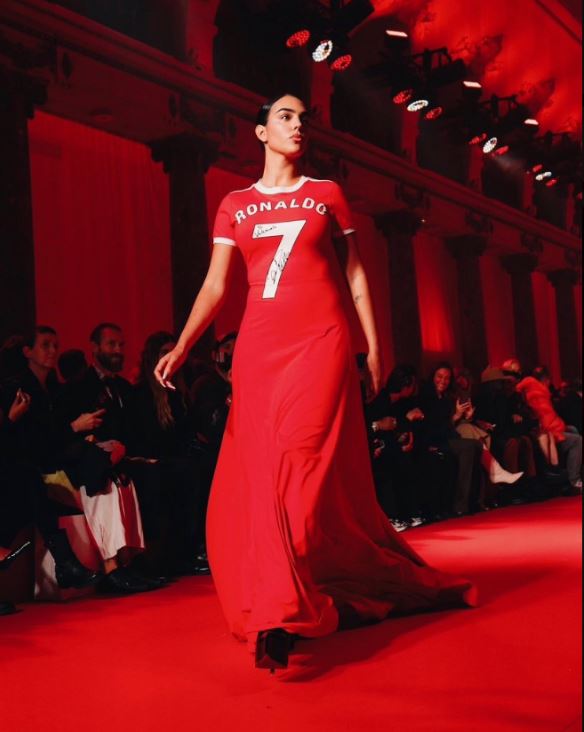 The influencer, 30, wore a red dress which featured the number seven on the front and he surname of her partner